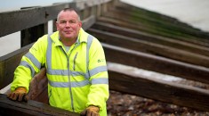 Man in high vis jacket on a roof