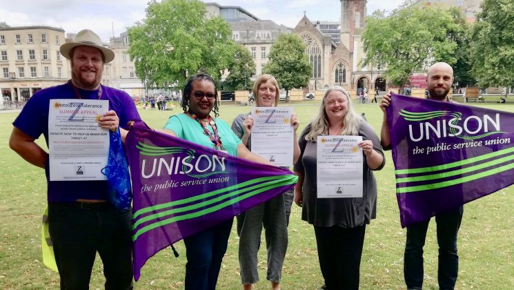 Members of Bristol UNISON branch hold purple and green UNISON flags and zero tolerance campaign posters to show support for the summer appeal.