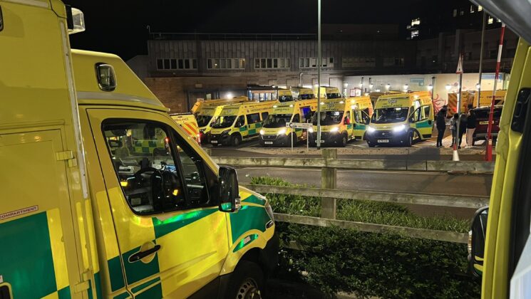 Ambulances queuing outside a hospital at nighttime on 15th May 2022