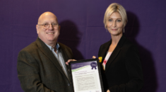 Emma Wood presented with UNISON's End Violence at Work certificate in a frame after committing to the union's charter.