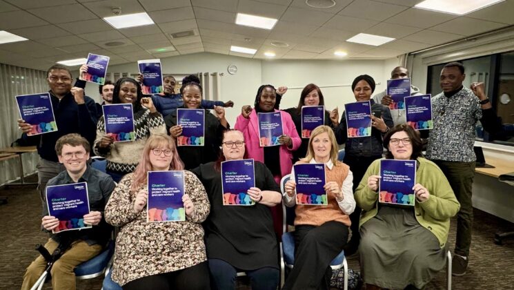 Migrant workers in Dorset holding the upcoming South West Migrant Workers Charter.