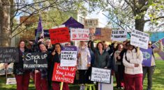Phlebotomists on the picket line holding homemade placards.