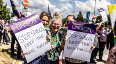 Staff protesting plans to create a SubCo in Dorset hold placards.