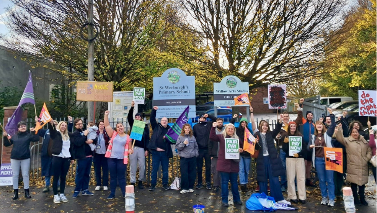 Staff on the picket line outside St Werburgh's Primary School holding placards and UNISON flags.