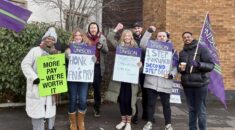 Second Step workers on the picket line holding placards.